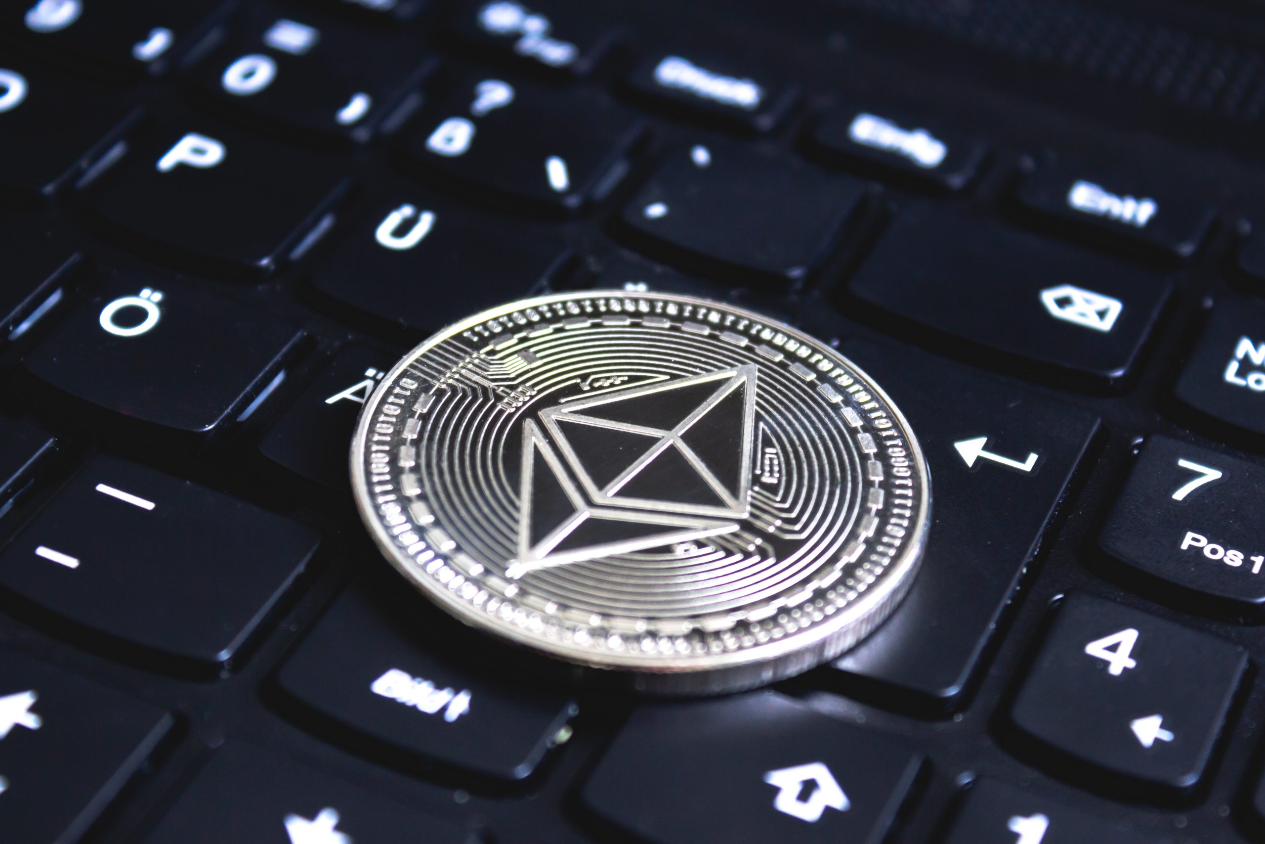 Tether Denies Investigation Rumors Amid Bitcoin Surge large coin placed on top of a black computer keyboard